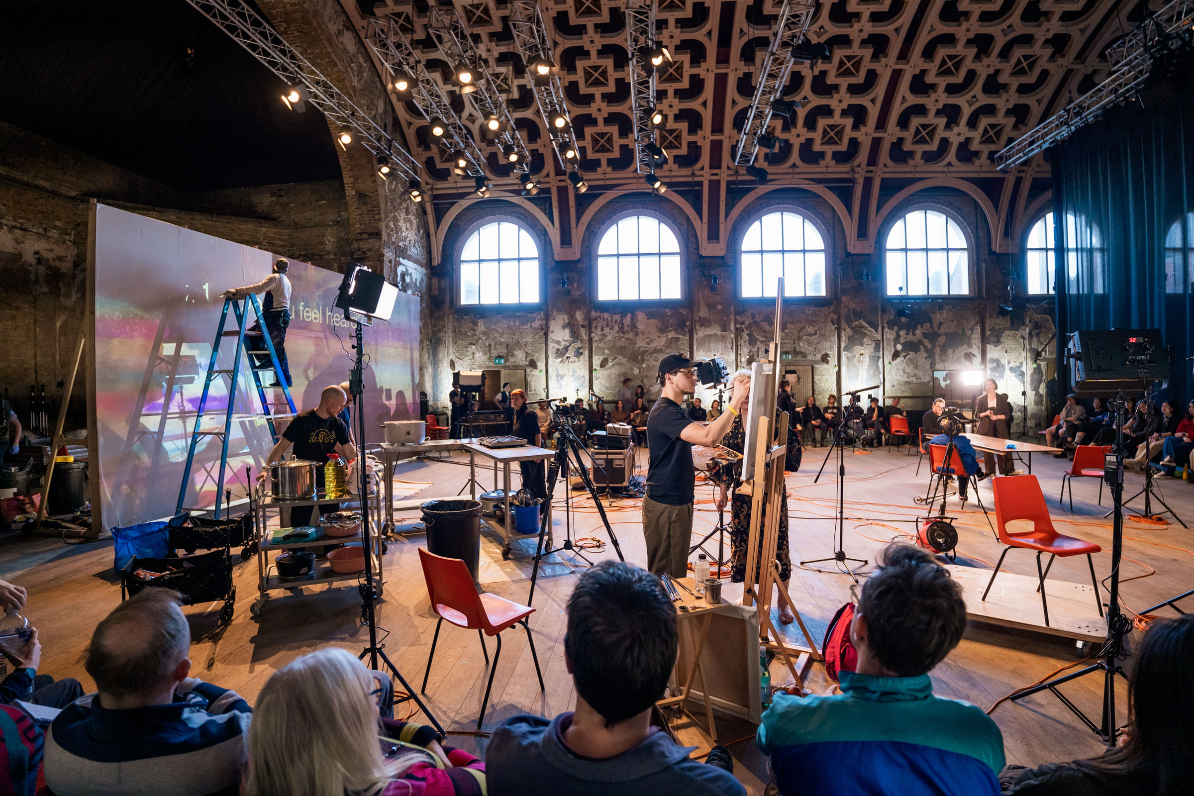 People on stage in 12 Last Songs in Battersea Arts Centre's Grand Hall