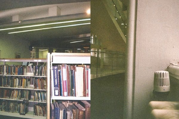 Photo of books on shelves in a library next to a view of stairs and a radiator