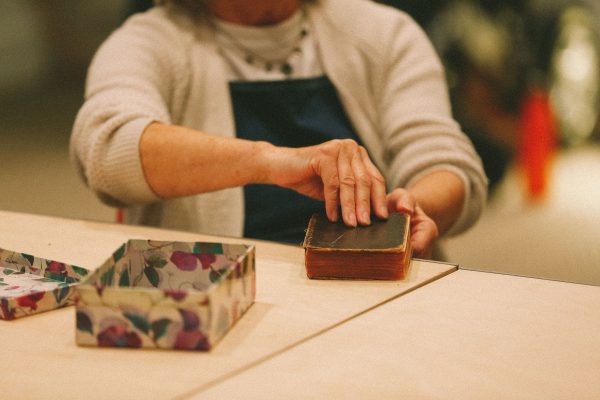 A person touches an old book